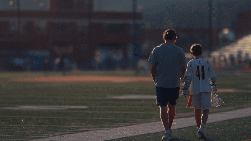 Parent and player walking off lacrosse field after a game